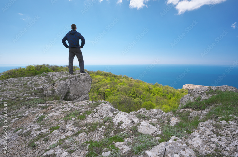 Man on sea cliff edge.