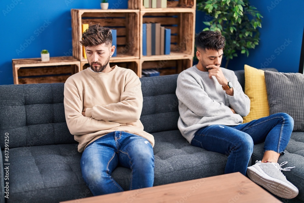 Young couple angry for disagreement sitting on sofa at home Young couple angry for disagreement sitting on sofa at home
