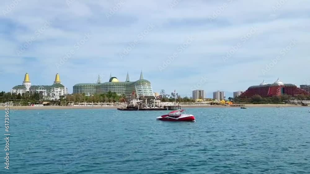 Antalya, Turkey, June 10, 2023. The blue Mediterranean sea and the coast with a beach and a variety of buildings, structures and hotels Antalya, Turkey, June 10, 2023. The blue Mediterranean sea and the coast with a beach and a variety of buildings, structures and hotels