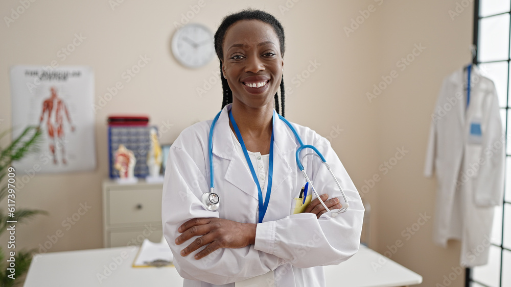 African american woman doctor smiling confident standing with arms crossed gesture at clinic African american woman doctor smiling confident standing with arms crossed gesture at clinic