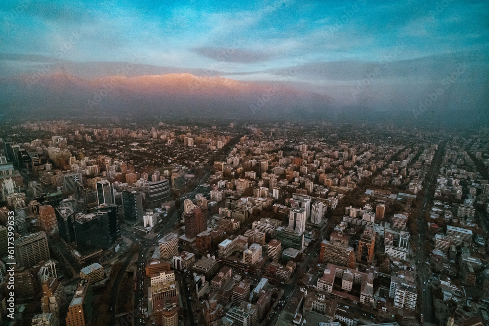 Fototapeta premium sunrise over the mountains and the skyline of santiago de chile