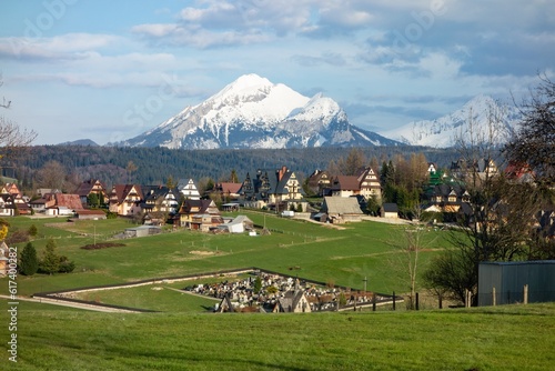 Landscape of High Tatras with luxury villas in Murzasichle village providing accommodation and graveyard photo