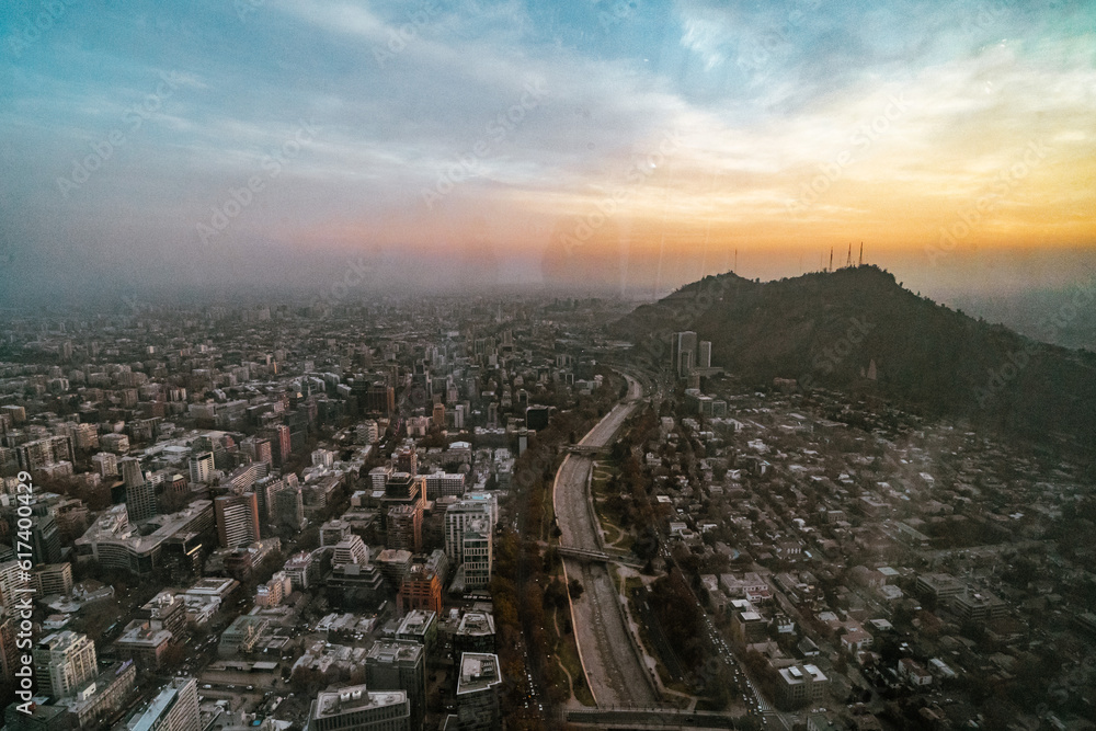 Fototapeta premium sunrise over the mountains and the skyline of santiago de chile