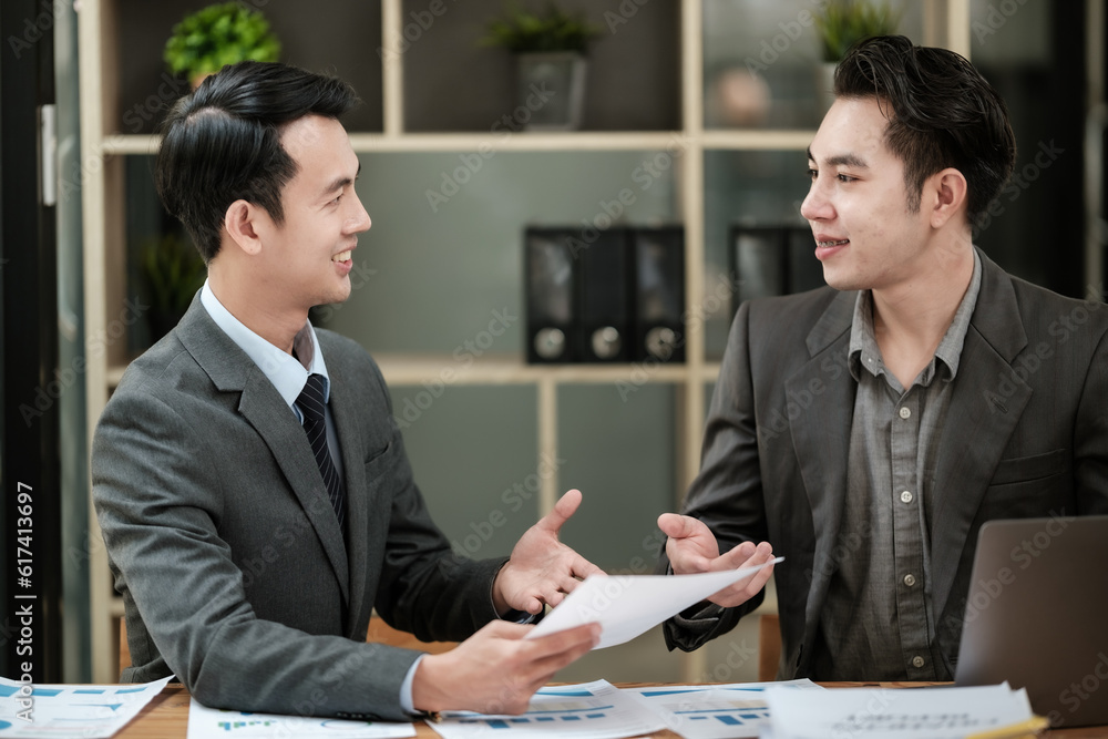 Group of business man discussion and brainstorming, bookkeeping audit graph and chart documents at desk, teamwork concept.