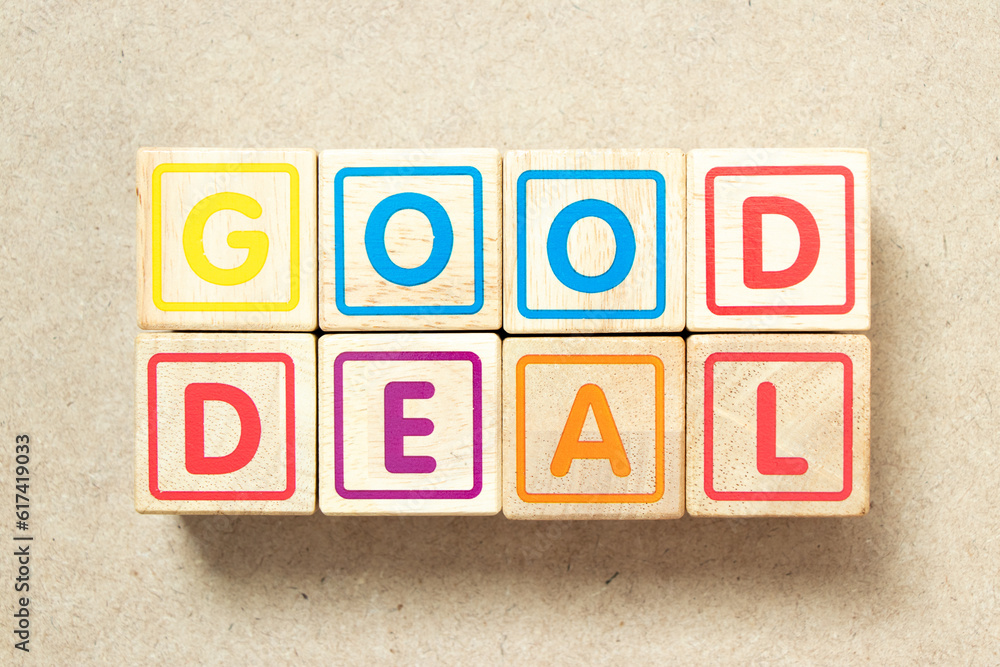 Wooden alphabet letter block in word good deal on wood background Wooden alphabet letter block in word good deal on wood background