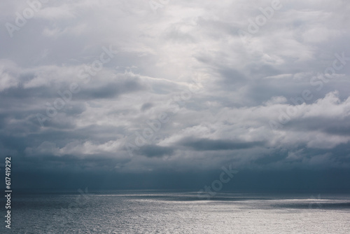 Storm clouds over the Pacific ocean at dusk photo