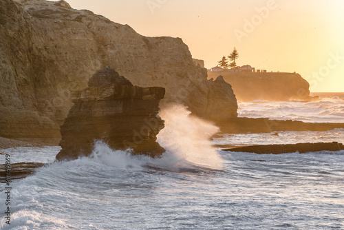 Ocean wave breaking on rocky shore in Algarve region of Portugal
