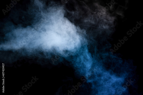 Blue and yellow steam on a black background. © Nikolay