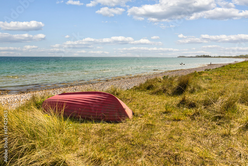 Fototapeta Naklejka Na Ścianę i Meble -  Red row boat at Baltic Sea coast, Danish island of Als