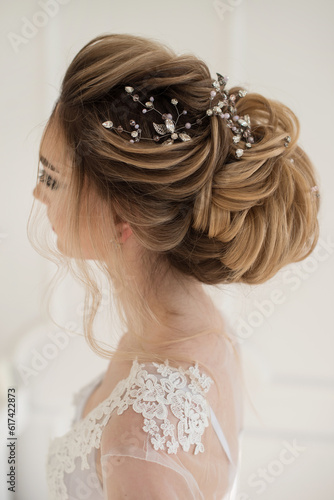 Textured gathered blonde bride hairstyle with sparkly accessories