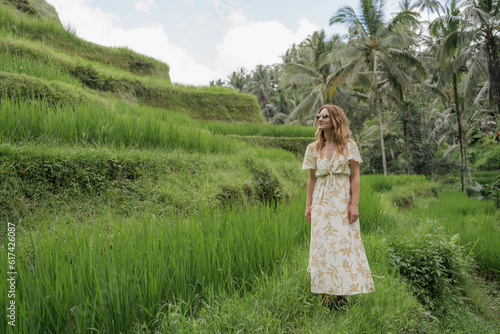 Young woman traveller enjoy walking on Tegalalang Rice Field at Ubud, Bali, Indonesia