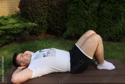 Man does lower back exercise Pelvic tilt