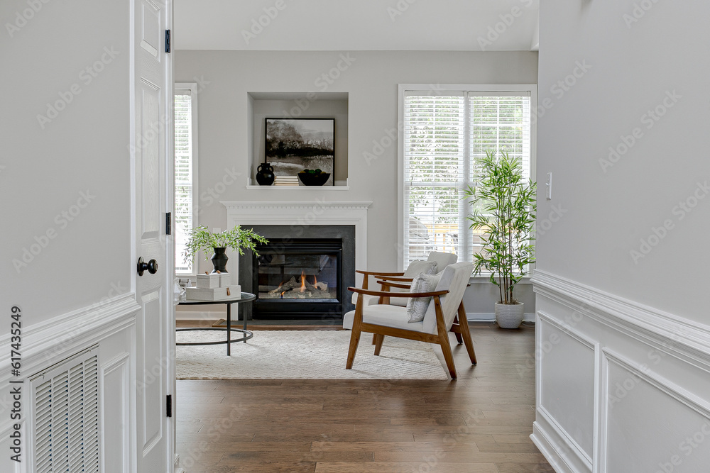 Interior Modern Sustainable The Family Room Interior With Wooden Boucle Accent Chairs And Black Fireplace With Styled Mantle