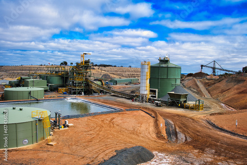 The Central Norseman gold mine in Norseman, Western Australia, with CIL tanks, tailings thickener pad, industrial buildings and heavy machinery.
 photo