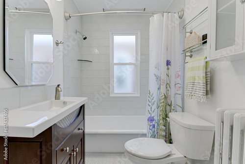Beautiful Chic Residential Traditional Modern Farmhouse White Bathroom Interior with tub shower backsplash wooden sink vanity