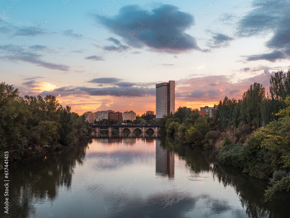 Sunset in the cityscape of Valladolid with the Puente Mayor bridge upon the Pisuerga river.Sunset in the cityscape of Valladolid with the Puente Mayor bridge upon the Pisuerga river.