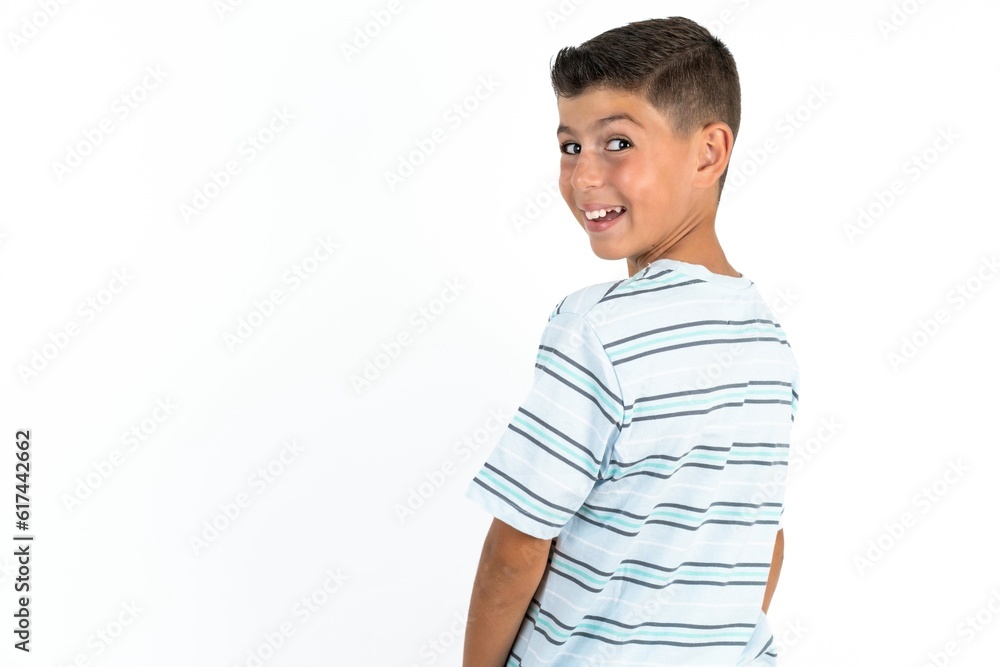 Satisfied pretty Little hispanic boy wearing striped shirt beaming smile look camera Satisfied pretty Little hispanic boy wearing striped shirt beaming smile look camera
