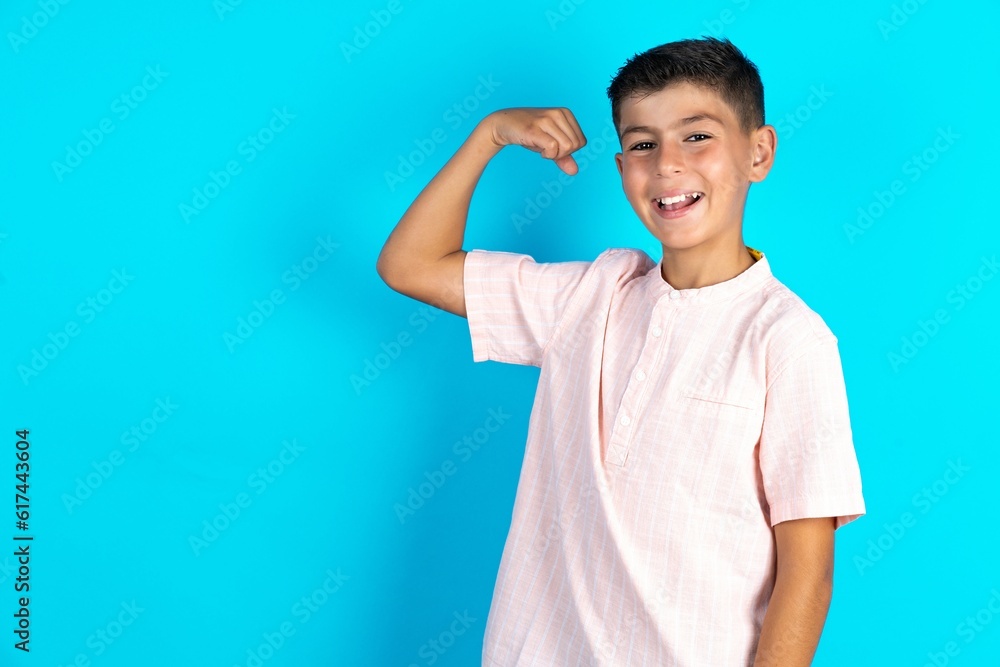 Profile photo of Little hispanic boy wearing white shirt supporting soccer team raise fist shouting Profile photo of Little hispanic boy wearing white shirt supporting soccer team raise fist shouting