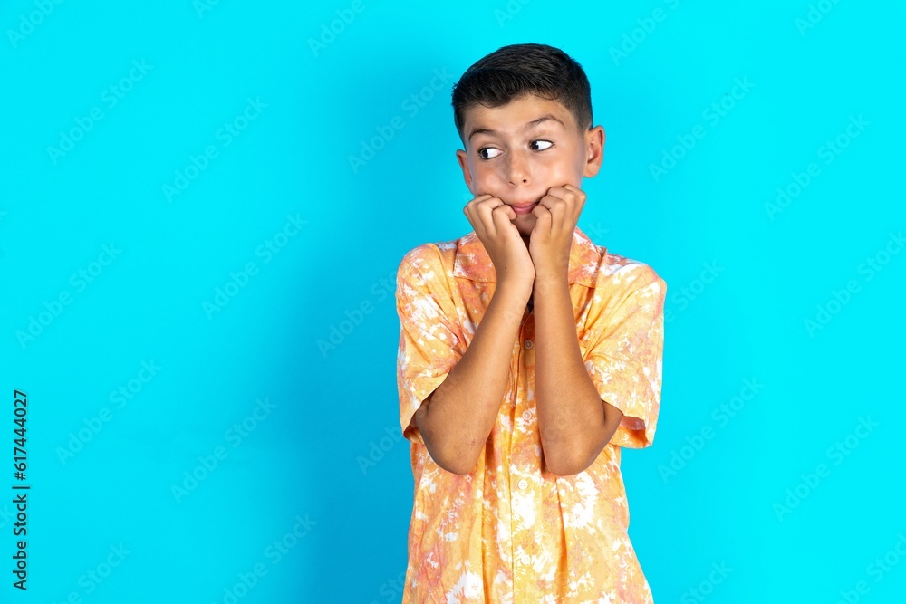 Terrified Little hispanic boy wearing hawaiian shirt looks empty space home alone moonless night Terrified Little hispanic boy wearing hawaiian shirt looks empty space home alone moonless night