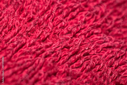 Close-up of a red terry towel as a background. Macro microfiber cloth