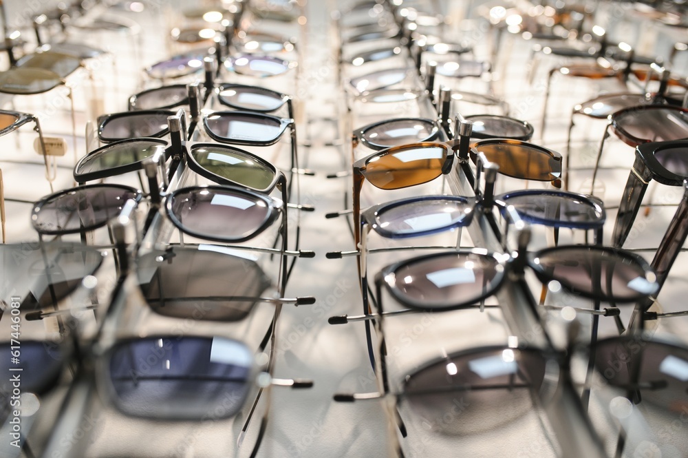 Fototapeta premium Sunglasses on display shelves in glasses store