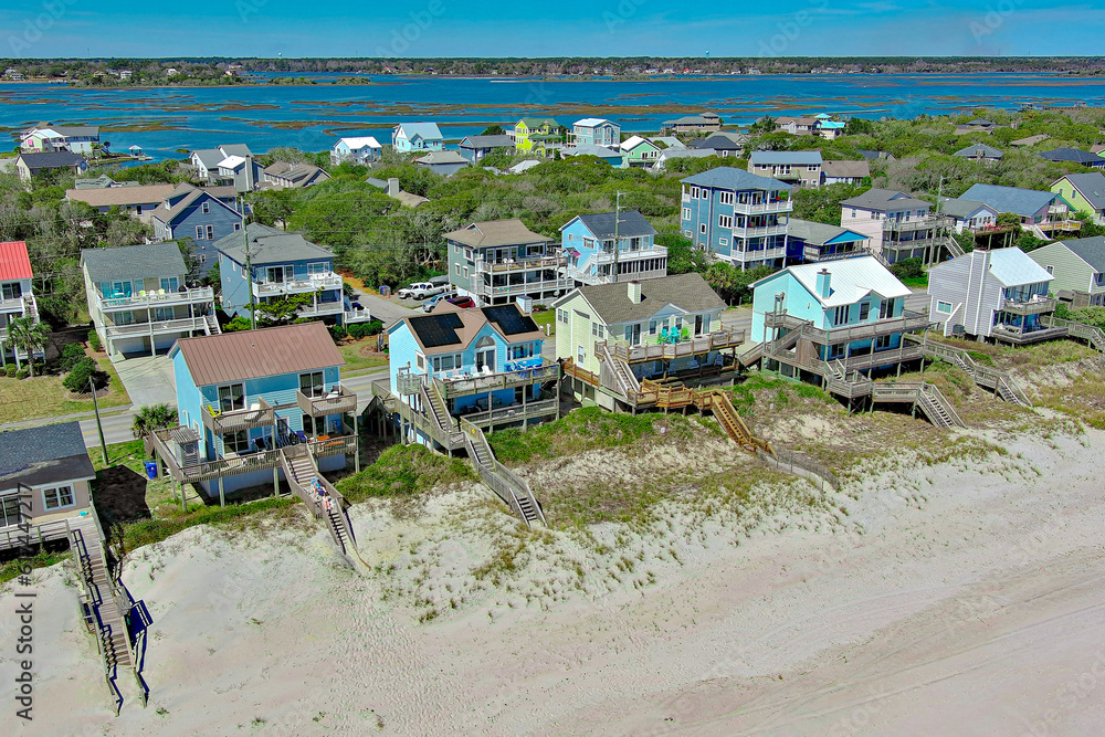 Drone view of a strip of beach houses along the coast of Surf City, NC.