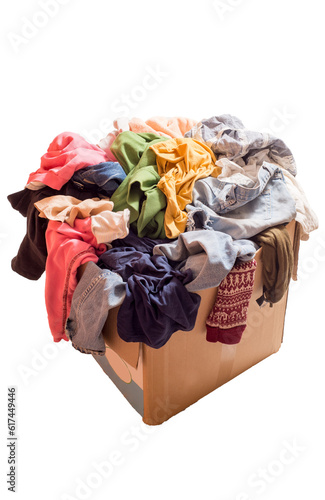 Pile of clothes in a large cardboard box. Decluttering the wardrobe. Preparing for the move. Recyclable textiles isolated
