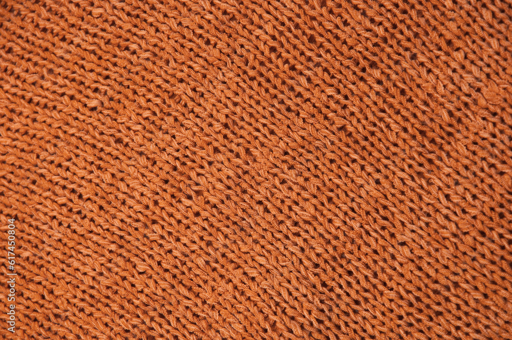 Fototapeta premium orange unusual texture.knitted brown sweater close up. handmade concept 