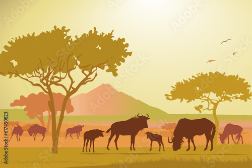 African savannah landscape with wildebeest silhouettes  midday sun  yellow background. Vector illustration.