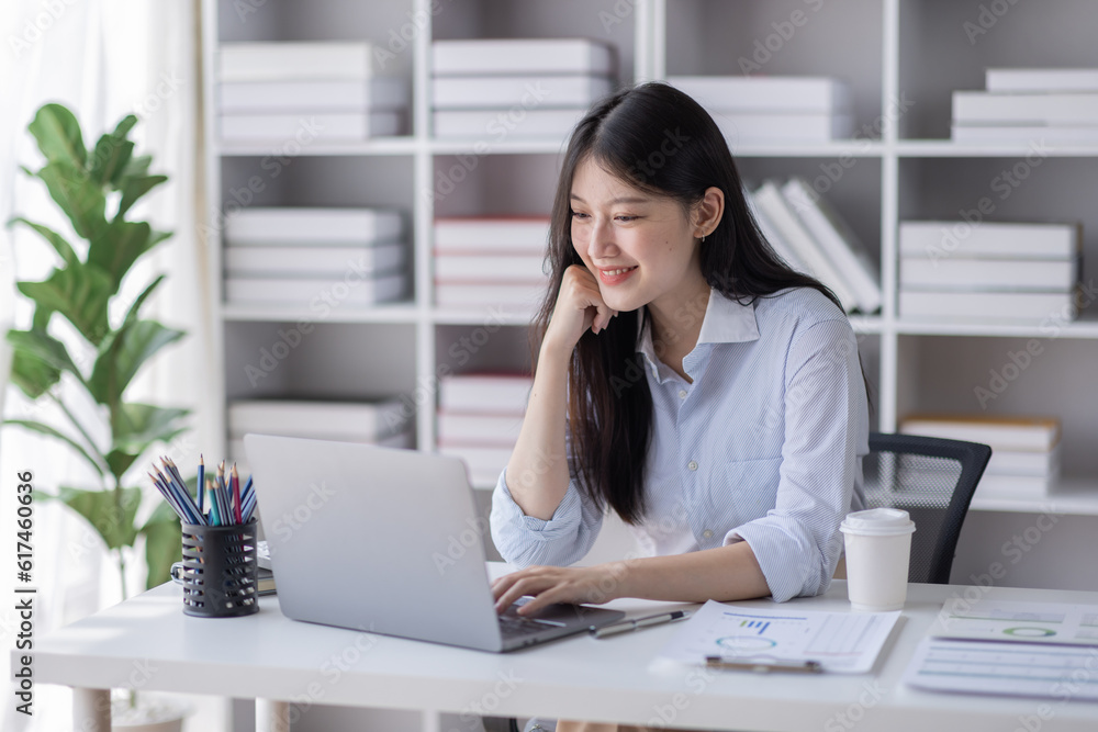 Φωτογραφία Business Asian woman work documents on laptop computer at office with calculator accounting on desk, do planning analyzing the financial report, business plan investment, finance analysis concept