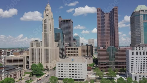 Drone moving aerial above LeVeque Tower and hotel in downtown district and capital city of Ohio in Columbus, OH photo