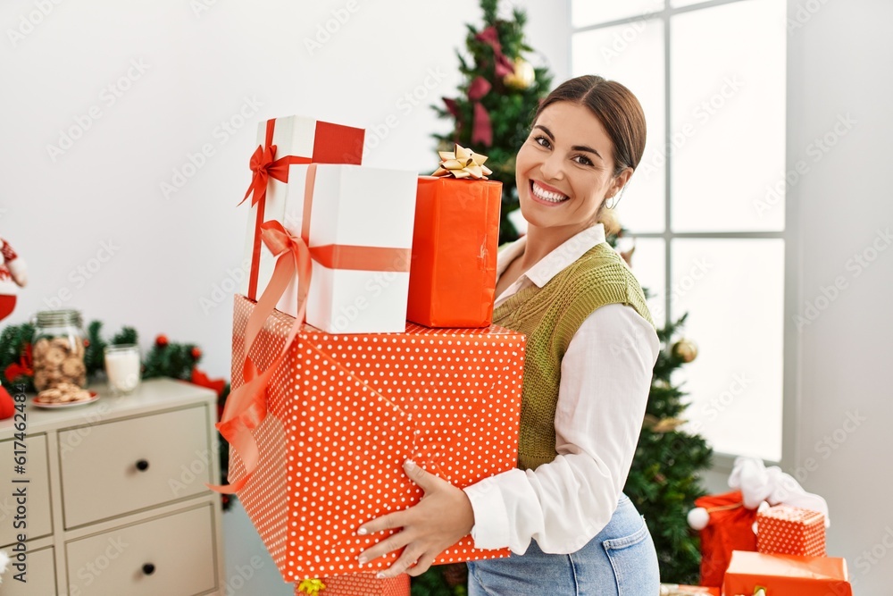 Beautiful Young Woman Wrapping Christmas Gifts Home Stock Photo by