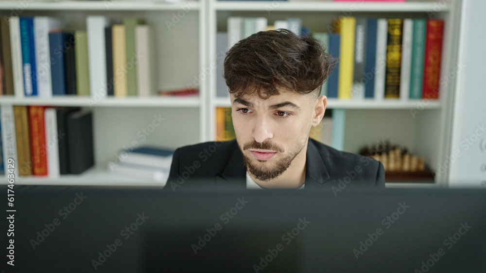 Young arab man student using computer studying at university classroom Young arab man student using computer studying at university classroom