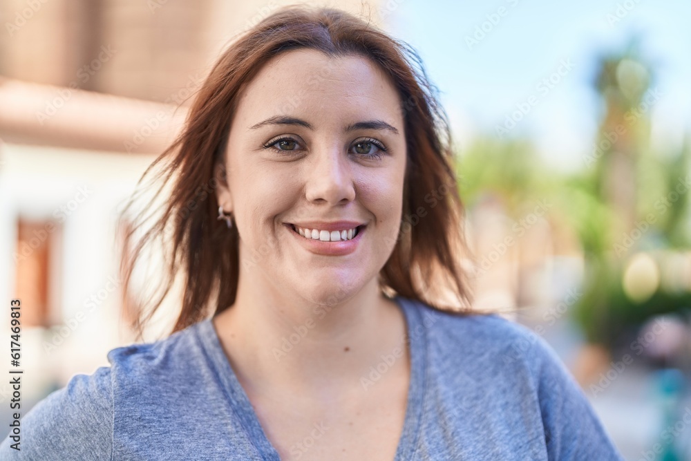 Young beautiful plus size woman smiling confident standing at street Young beautiful plus size woman smiling confident standing at street