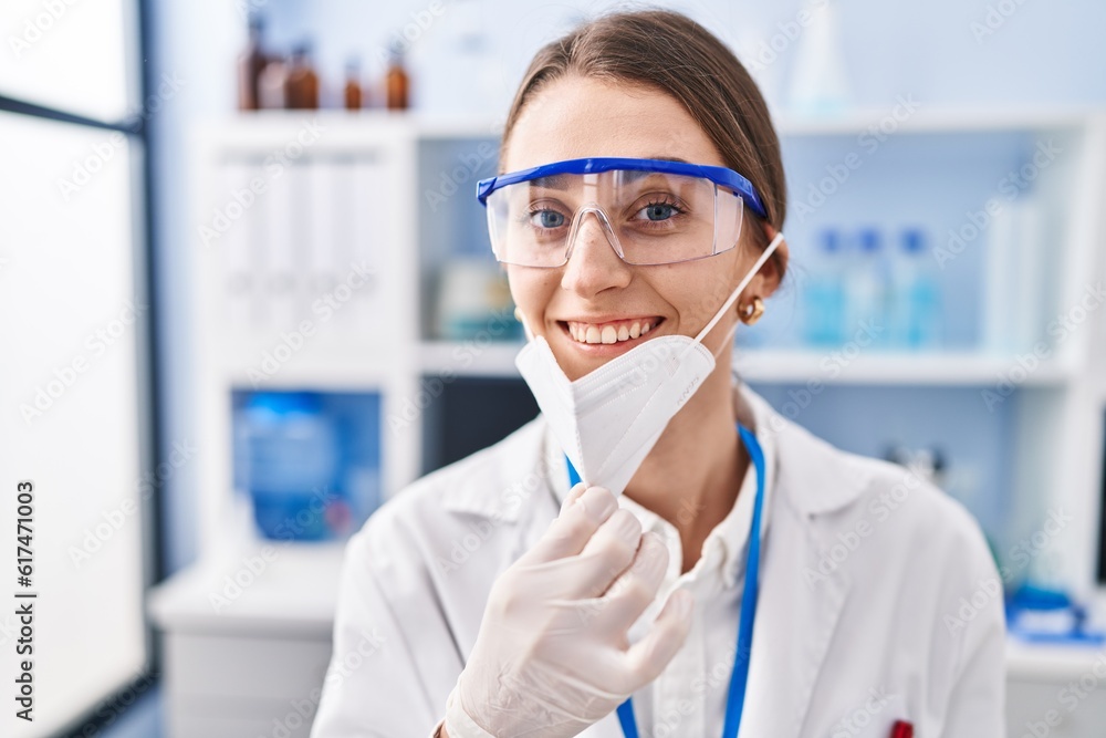 Young caucasian woman scientist wearing medical mask at laboratory Young caucasian woman scientist wearing medical mask at laboratory