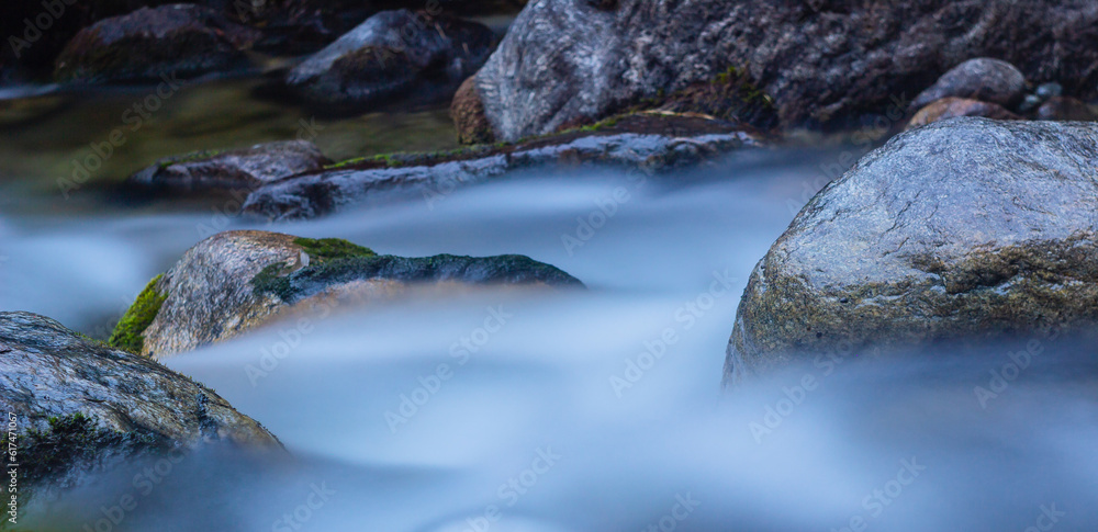 River water flows over rocks in rapids captured in slow motion in the tropical cloud forest.
Milky appearance. Slow motion water running through the forest among the jungle. Slow shutter speed. River water flows over rocks in rapids captured in slow motion in the tropical cloud forest.
Milky appearance. Slow motion water running through the forest among the jungle. Slow shutter speed.