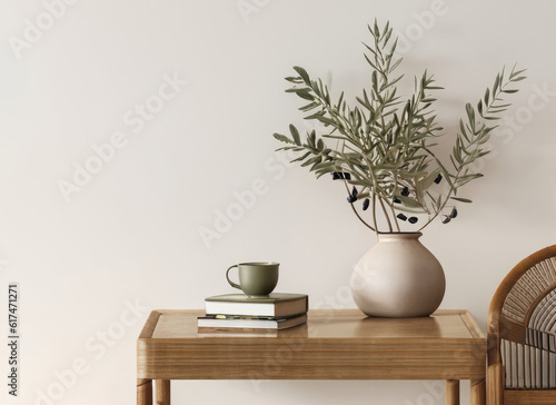 Modern organic shaped vase with dry flowers grass reed on old books Cup of coffee tea house