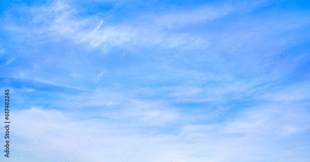 Bright blue sky with fine cirrus clouds, abstract nature background