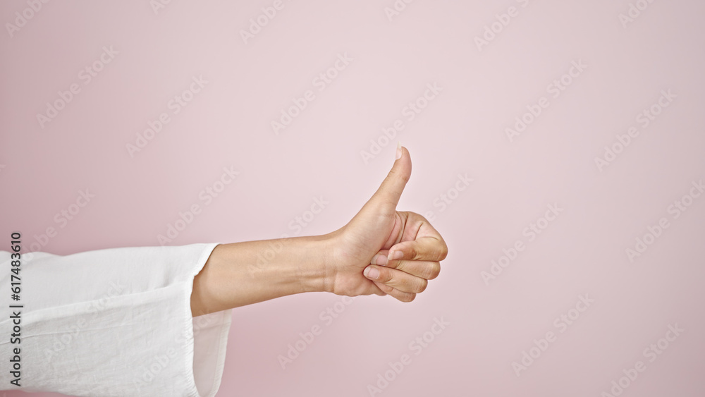 Young beautiful hispanic woman with thumb up over isolated pink background