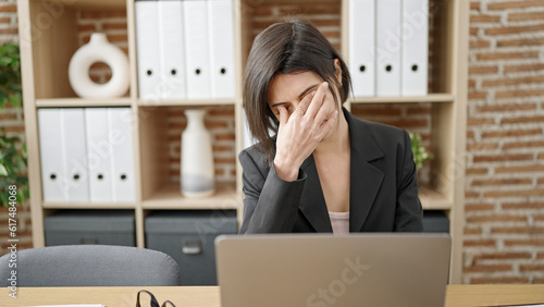 Young caucasian woman business worker stressed using laptop at office