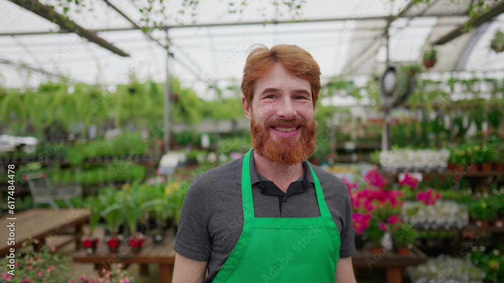 Obraz premium Portrait of a Smiling Red-Haired Male Employee smiling at camera in Flower Shop