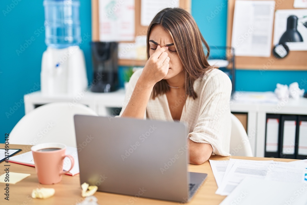 Young beautiful hispanic woman business worker stressed using laptop at office