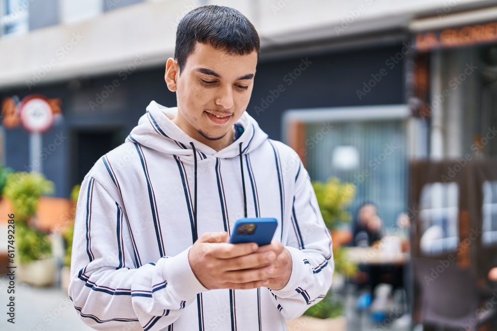Young man smiling confident using smartphone at street Young man smiling confident using smartphone at street