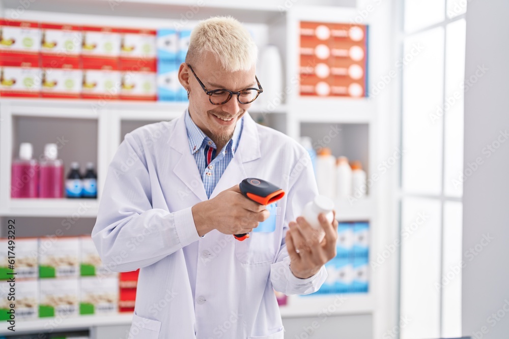 Young caucasian man pharmacist scanning pills at pharmacy