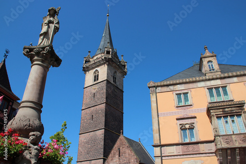 chapel tower, town hall and fountain in obernai in alsace (france)