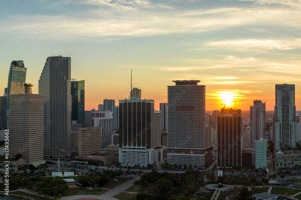 View from above of concrete and glass skyscraper buildings in downtown district of Miami Brickell in Florida, USA at sunset. American megapolis with business financial district at nightfall