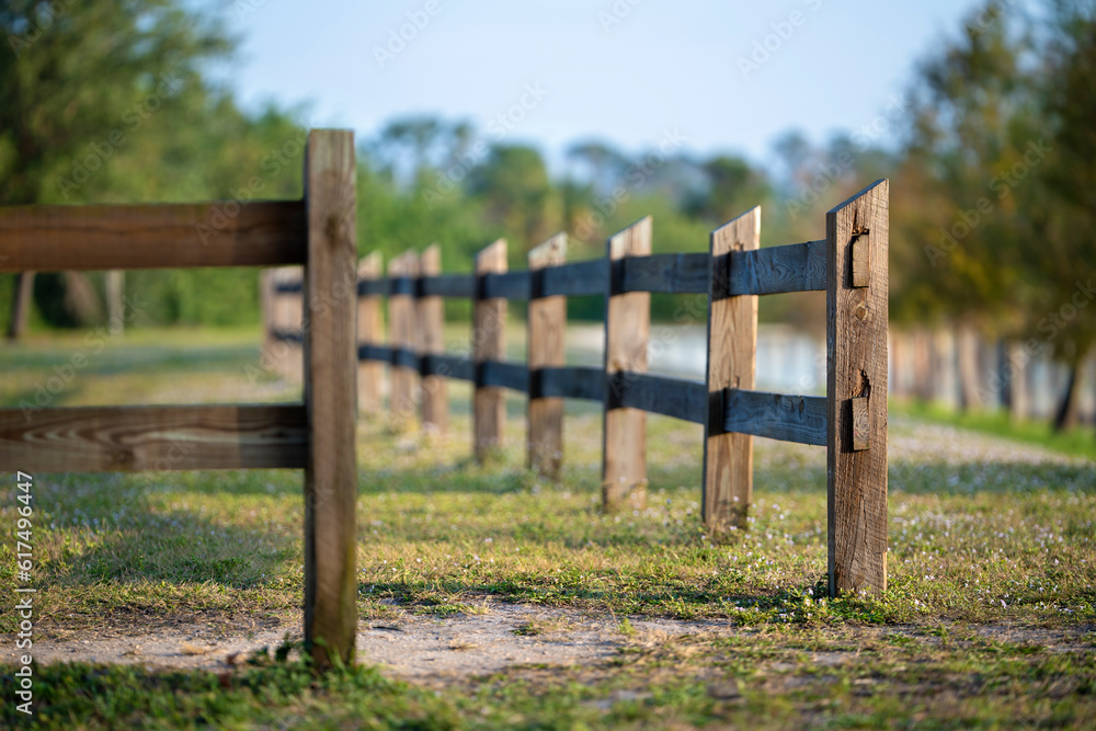 Wooden fence barrier at farm grounds for cattle and territory protection Wooden fence barrier at farm grounds for cattle and territory protection