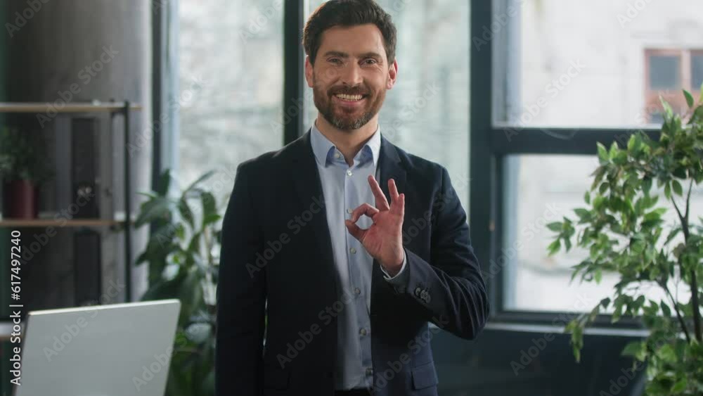 Smiling caucasian man entrepreneur client in office showing ok sign happy businessman company leader employer boss looking camera show approval symbol agreement gesture great result positive feedback Smiling caucasian man entrepreneur client in office showing ok sign happy businessman company leader employer boss looking camera show approval symbol agreement gesture great result positive feedback