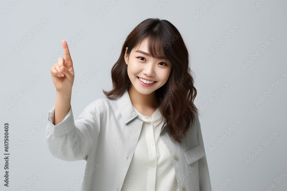 Pointing finger of an Asian girl highlights vacant space on a white background, making it a prime choice for a promotional advertising banner. Generative AI. Pointing finger of an Asian girl highlights vacant space on a white background, making it a prime choice for a promotional advertising banner. Generative AI.