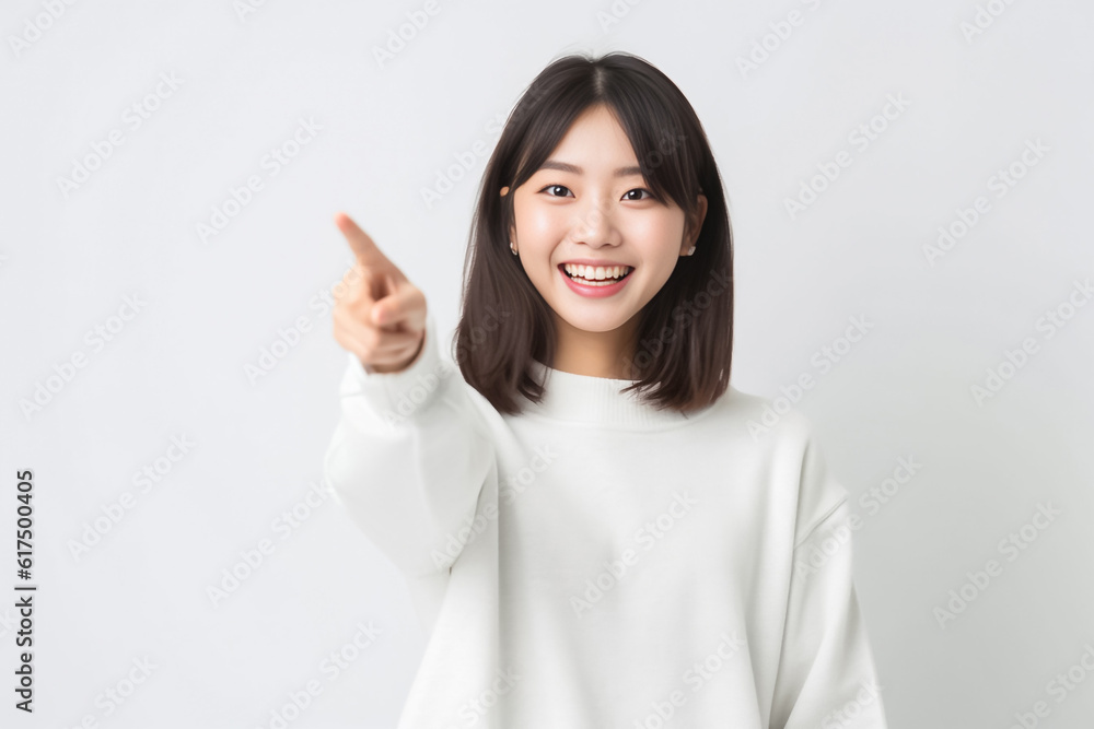 Pointing finger of an Asian girl highlights vacant space on a white background, making it a prime choice for a promotional advertising banner. Generative AI. Pointing finger of an Asian girl highlights vacant space on a white background, making it a prime choice for a promotional advertising banner. Generative AI.